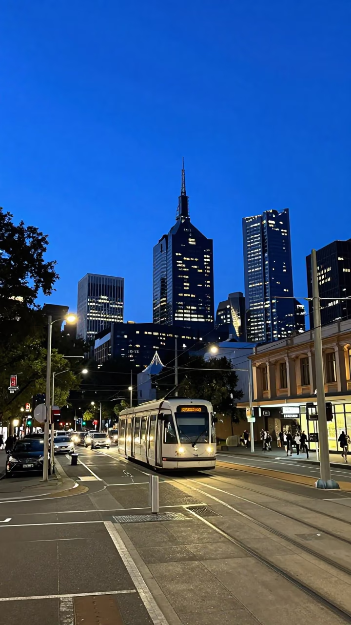 Melbourne indigo twilight street scene with tram tracks and city lights in in Melbourne, Victoria, Australia