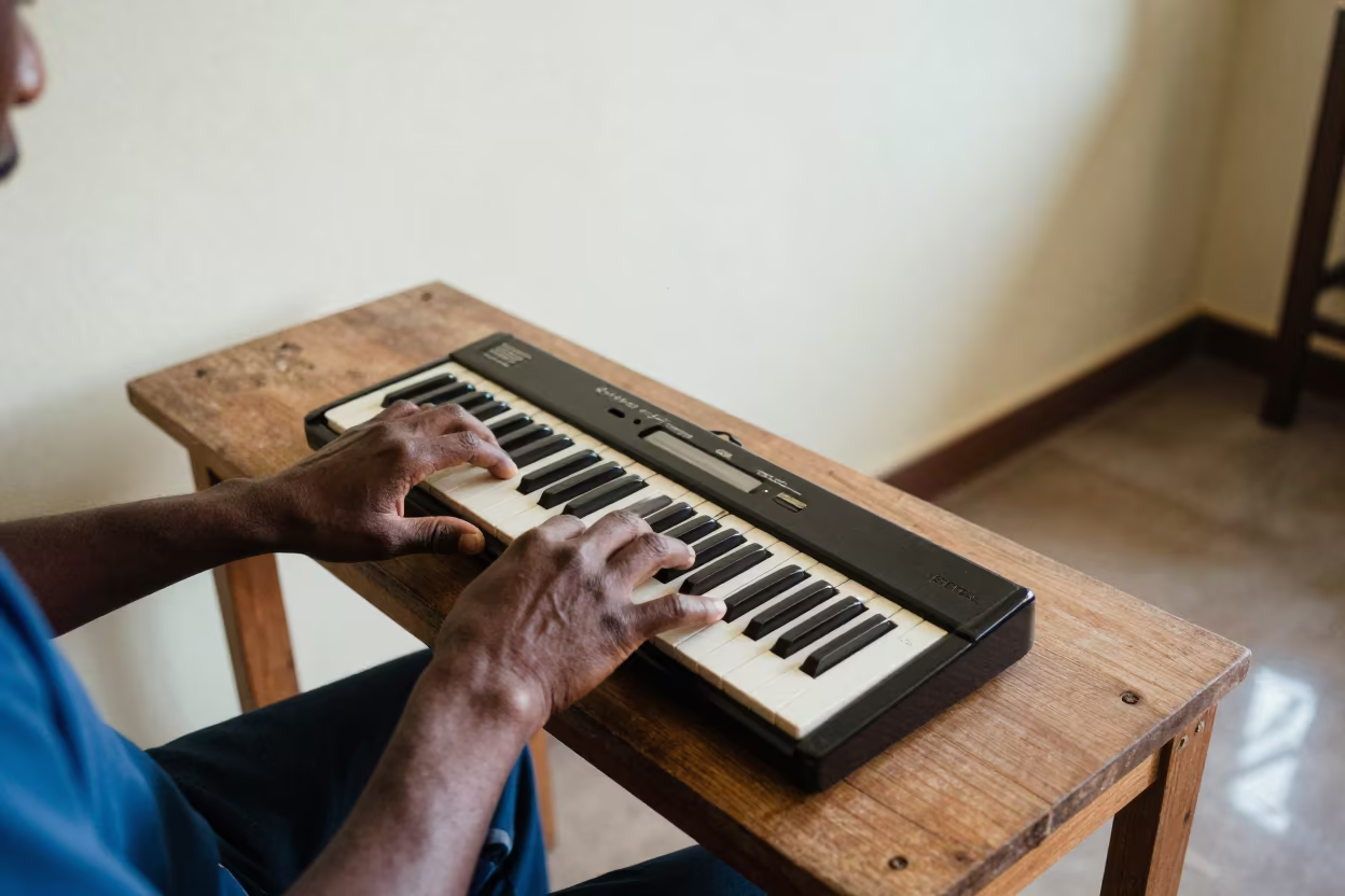 Melodica Player Jamming at Kampala Workbench in on a wooden workbench near Kampala