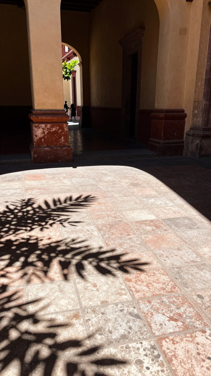 Merida Mexico noon sun leaf shadows tile street scene candid moment in in Merida, Mexico