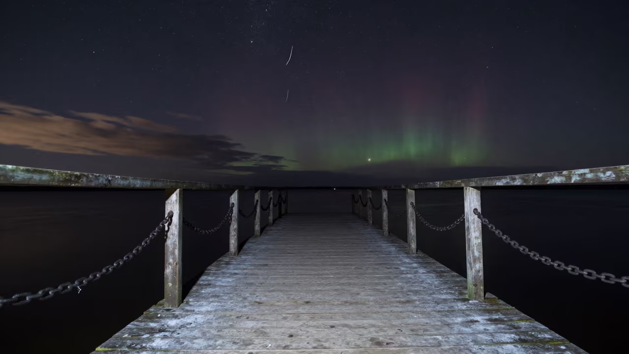Meteor Flash Over Winter Pier Lithuania Night in beneath thin cloud gaps and stars in Lithuania