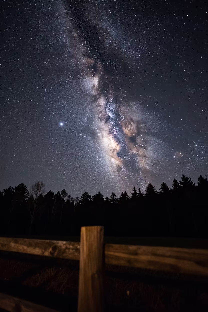 Meteor Streaking Past Milky Way Core Georgia Night in beneath thin cloud gaps and stars in Georgia
