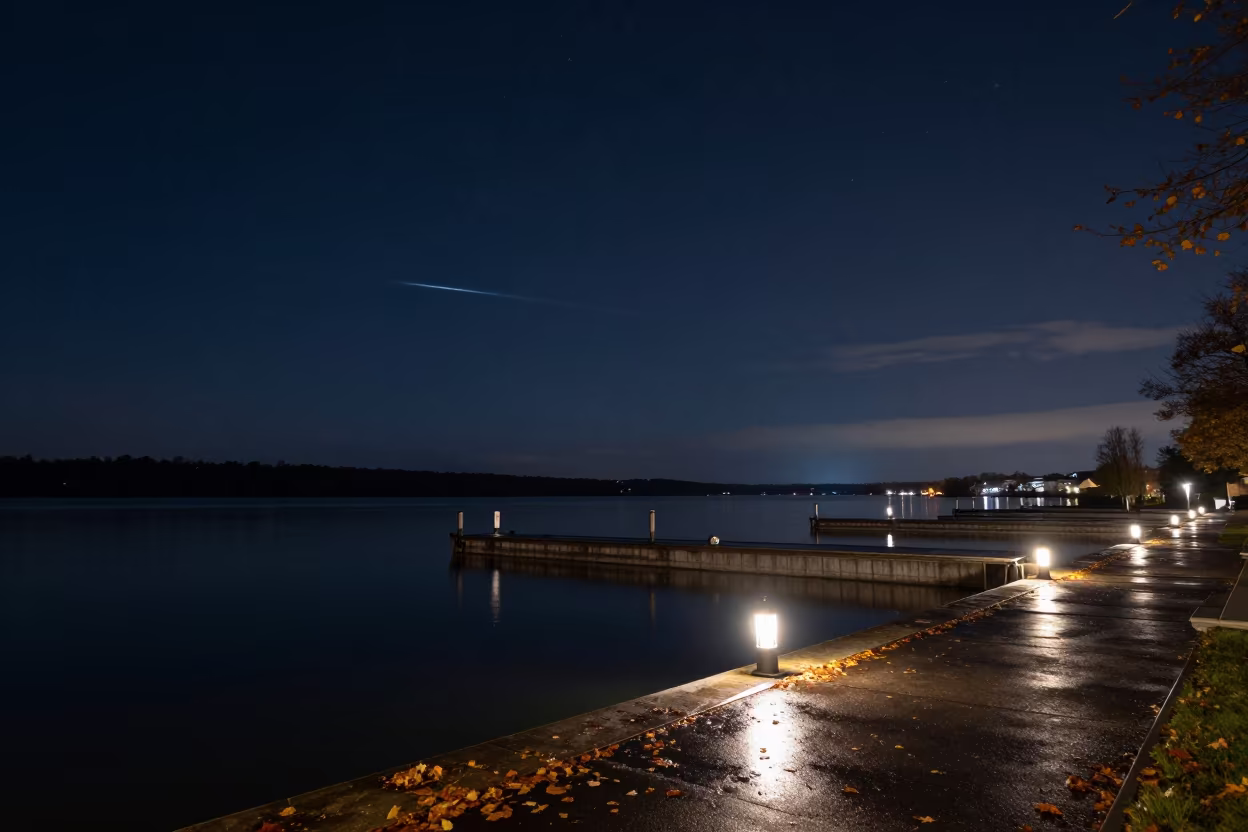 Meteor Streaking Over Autumn Lake at Stuttgart Harbor in beside a lantern-dotted harbor near Stuttgart