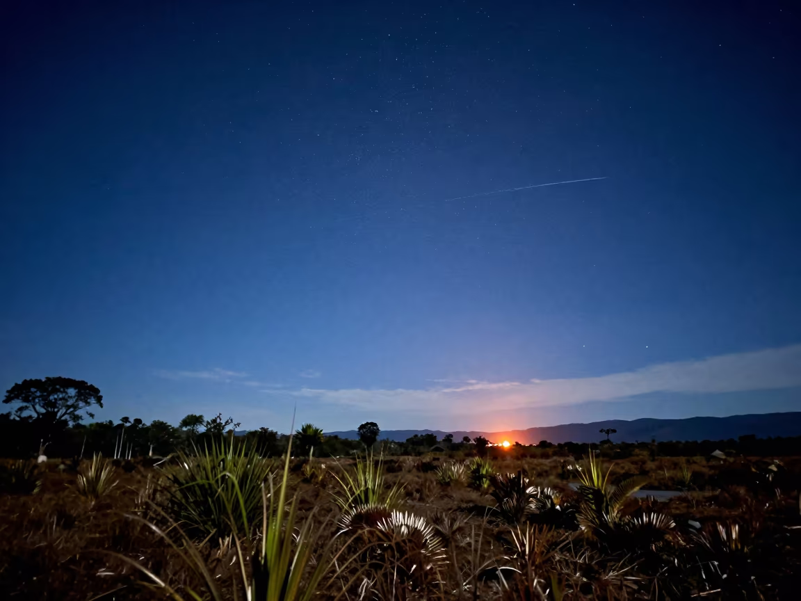 Meteor Streaking Over Colombian Night Sky in beneath a moon-washed horizon in Colombia