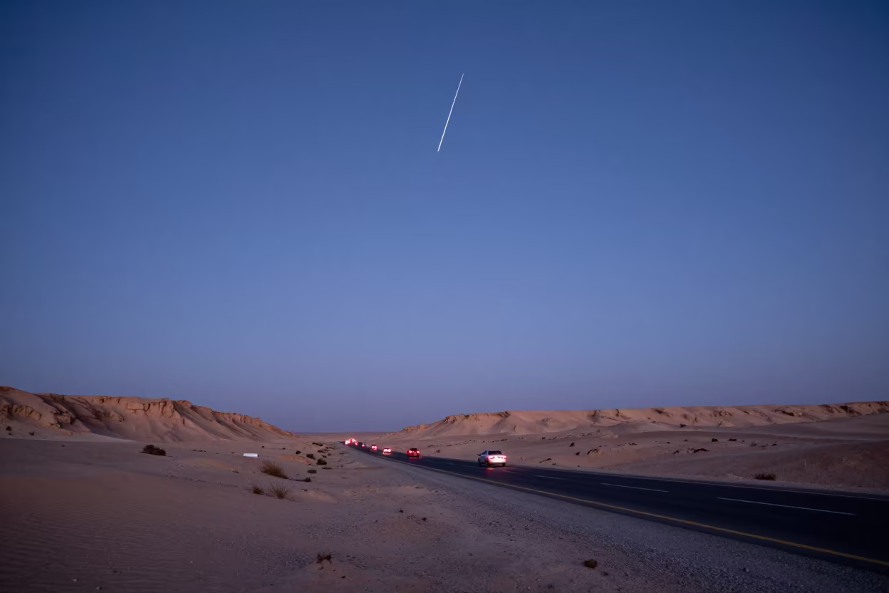 Meteor Trail Over Desert Road at Blue Hour in beneath a wind-cut desert escarpment near Riyadh