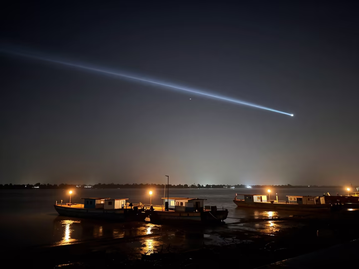 Meteor Trail Over Lantern-Dotted Bahawalpur Harbor in beside a lantern-dotted harbor near Bahawalpur
