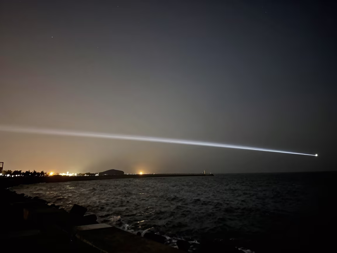 Meteor Trail Over Qingdao Breakwater Night in from a moonlit breakwater near Qingdao