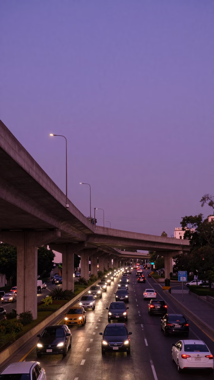 Mexico City evening traffic overpass interchange ramp against violet sky with distant buildings in in Mexico City, Mexico