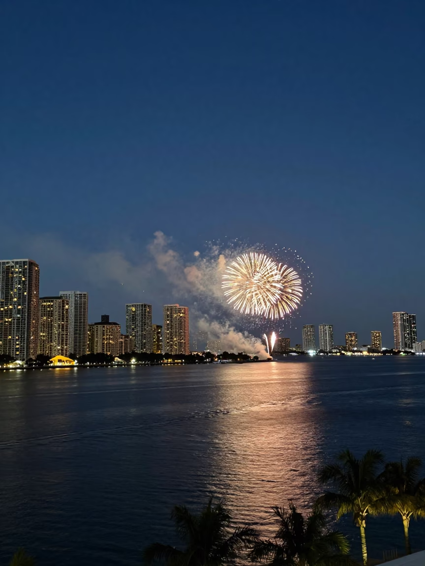 Miami Florida Harbor City Lights Glow and Fireworks Over Water at Dusk in in Miami, Florida, United States
