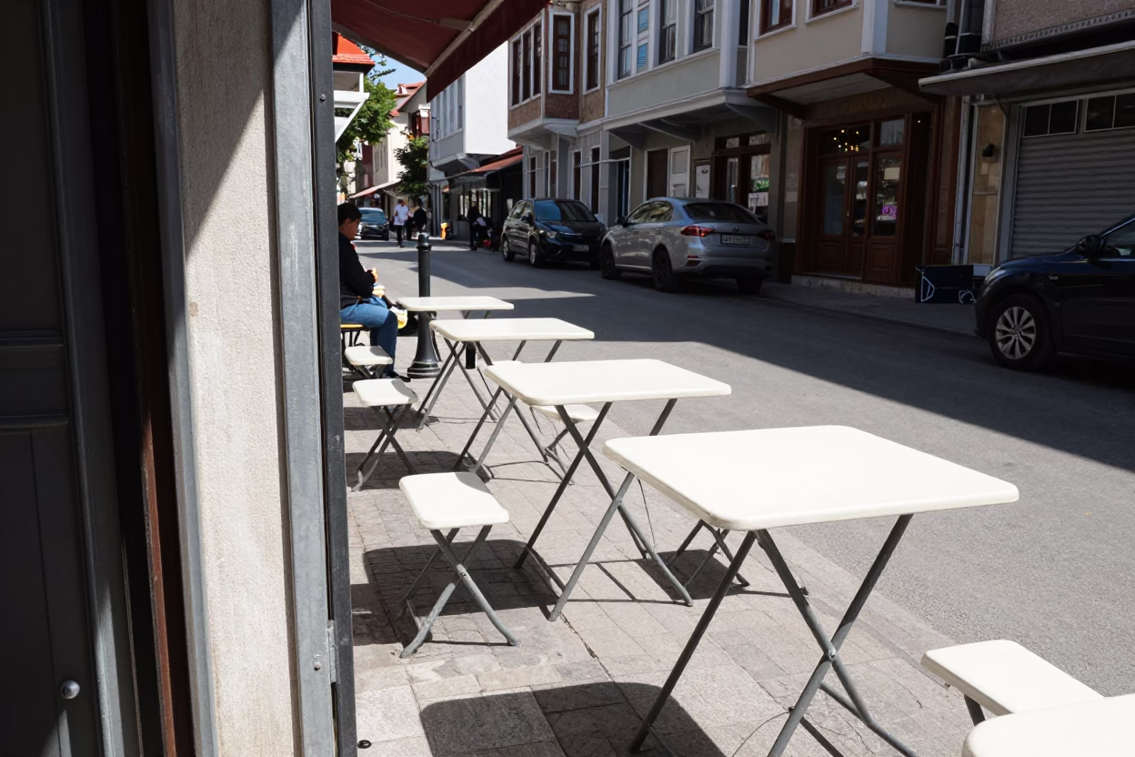 Midday Istanbul Street Scene with Folding Tables and Sunlit Hinge Details in in Istanbul, Turkey