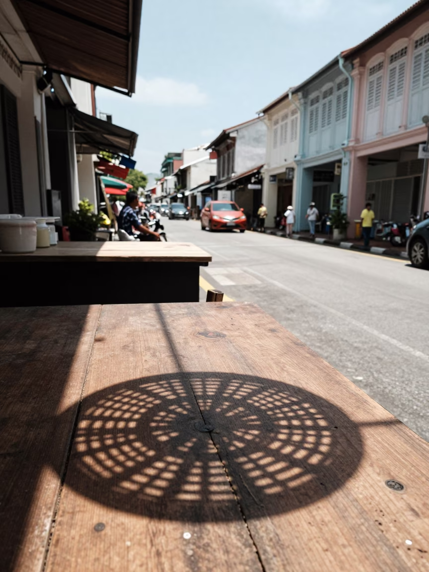 Midday Street Life in George Town Malaysia with Wicker Shadow on Countertop in in George Town, Malaysia