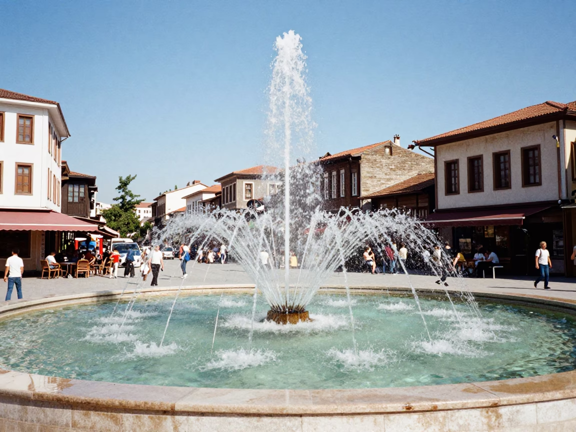 Midday street scene in Izmir Turkey with fountain spray and local architecture in in Izmir, Turkey