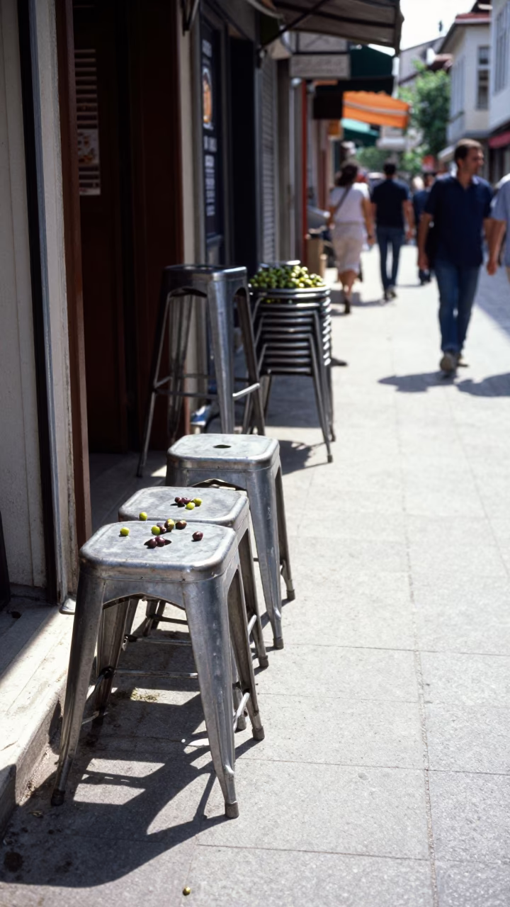 Midday Street Scene in Izmir Turkey with Metal Stools and Olives in in Izmir, Turkey