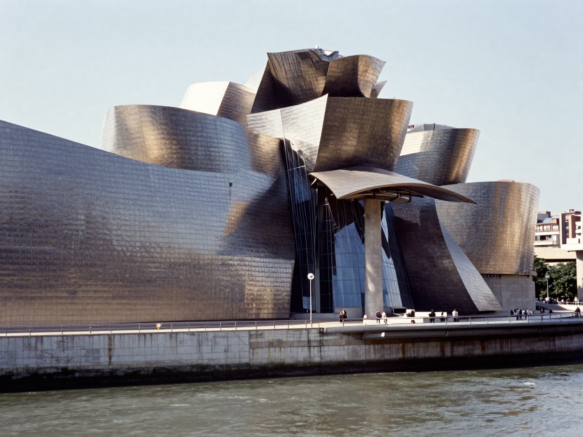 Midday Sunlight on Bilbao’s Guggenheim Museum Titanium Cladding and Nervión River Reflections in in Bilbao, Spain