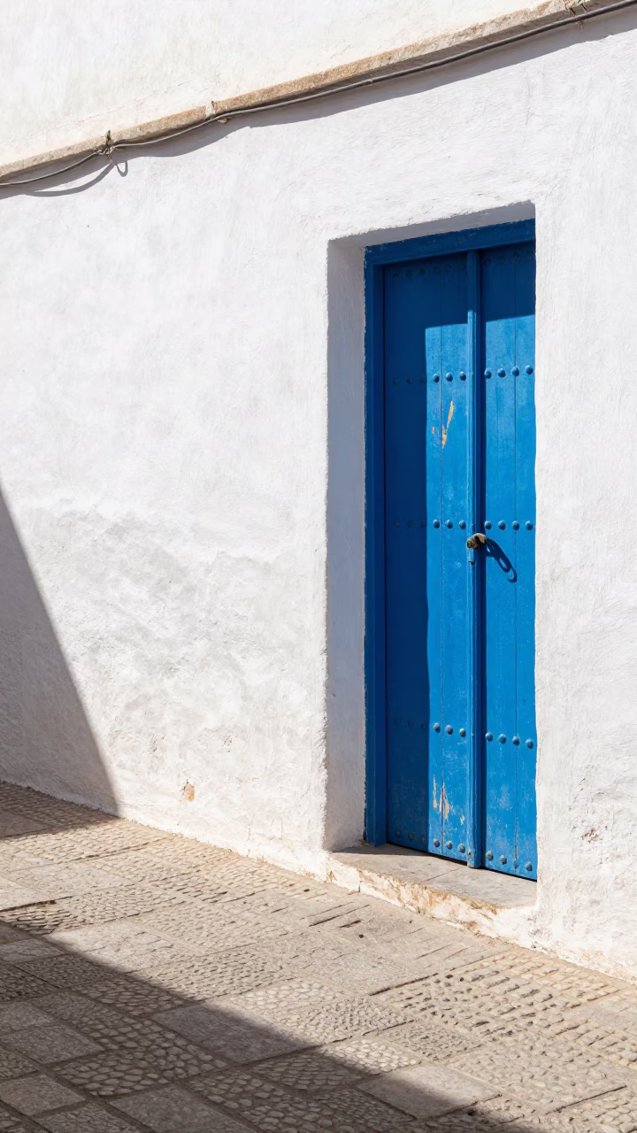 Midday Sunlight on Blue Wooden Doors and Cobblestone Streets in Essaouira Morocco in in Essaouira, Morocco