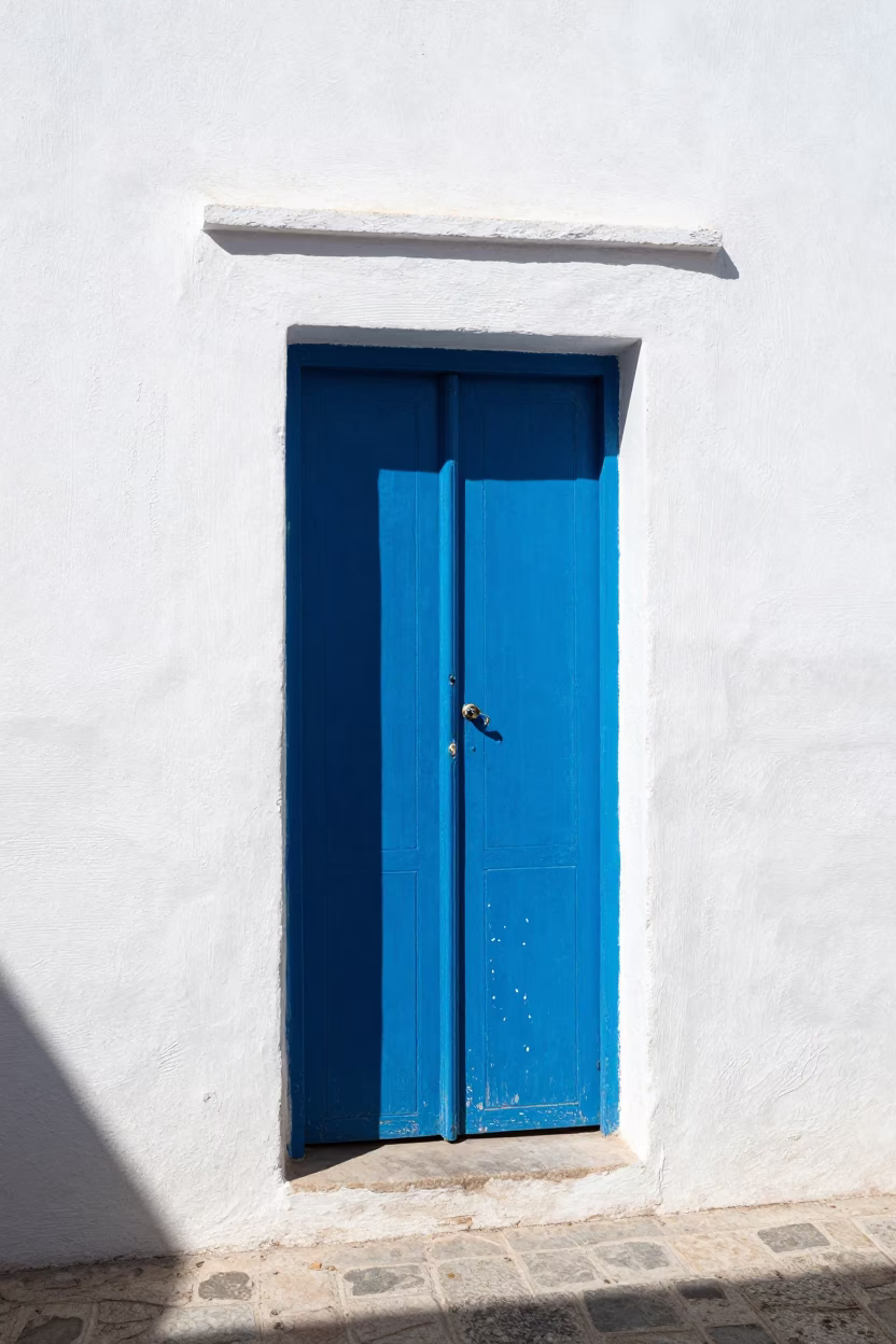 Midday Sunlight on Blue Wooden Doors and White Walls in Essaouira Morocco Street Scene in in Essaouira, Morocco