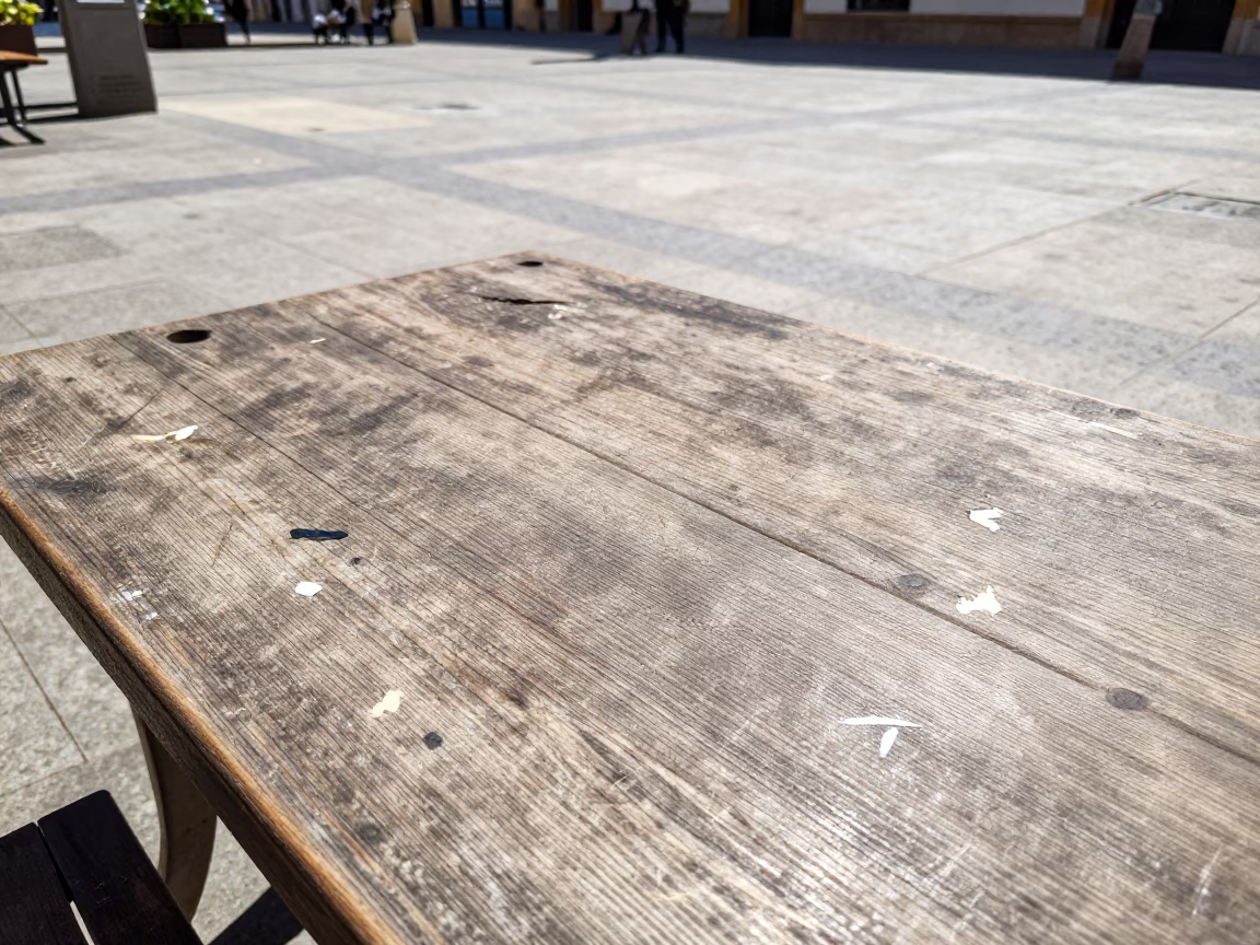 Midday Sunlight on Valencia Plaza Scratches and Paint Flecks Near Street Cafe in in Valencia, Spain