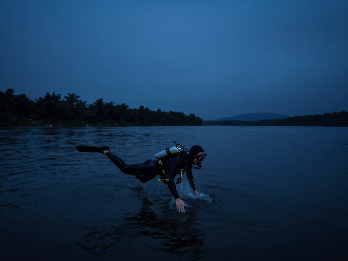 Midnight Diver Enters River Near Kowloon City in by a riverbank near Kowloon City, Hong Kong