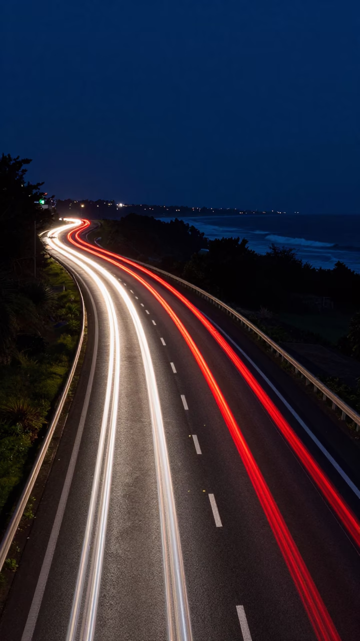 Midnight Durban Highway Long Exposure Car Headlight Trails and Coastal Surf in in Durban, South Africa