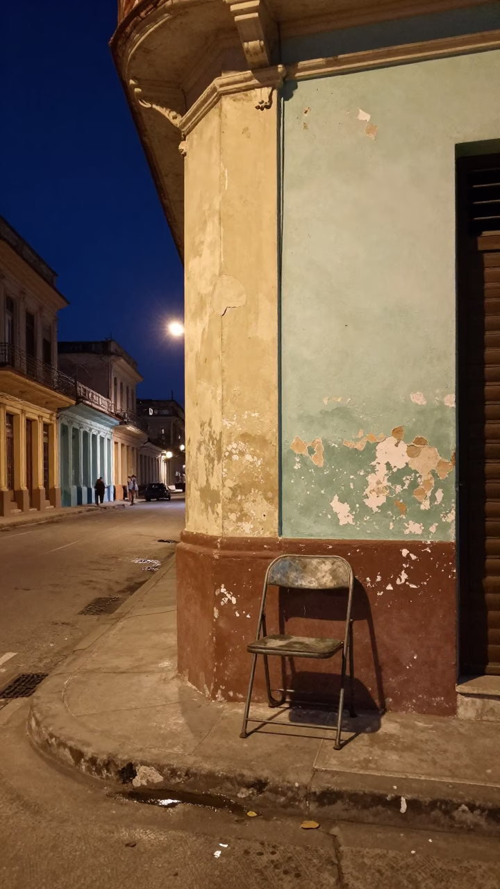 Midnight Havana Street Corner with Vintage Folding Chair and Local Interaction in in Havana, Cuba