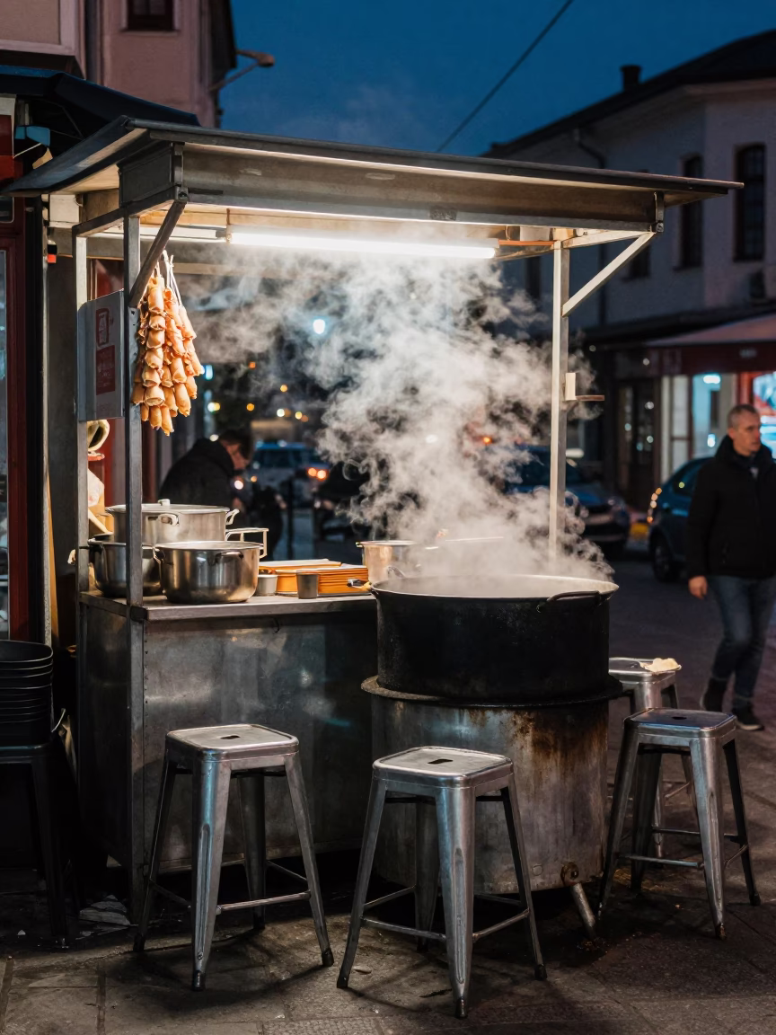 Midnight Istanbul Street Scene with Metal Stools and Cooking Pot Near Ferry in in Istanbul, Turkey