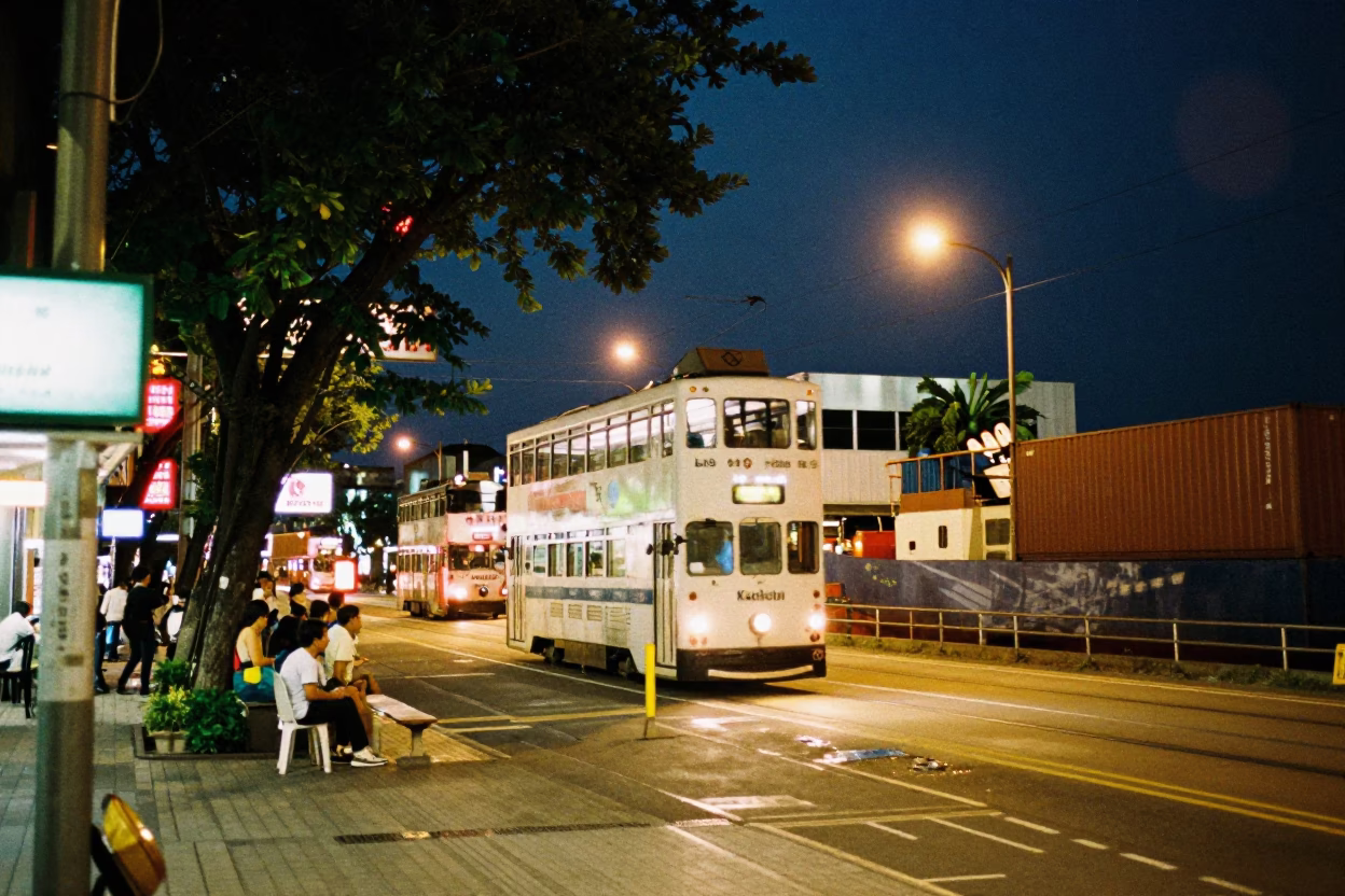 Midnight Kaohsiung Street Scene with Tramcar and Container Ship in Port in in Kaohsiung, Taiwan
