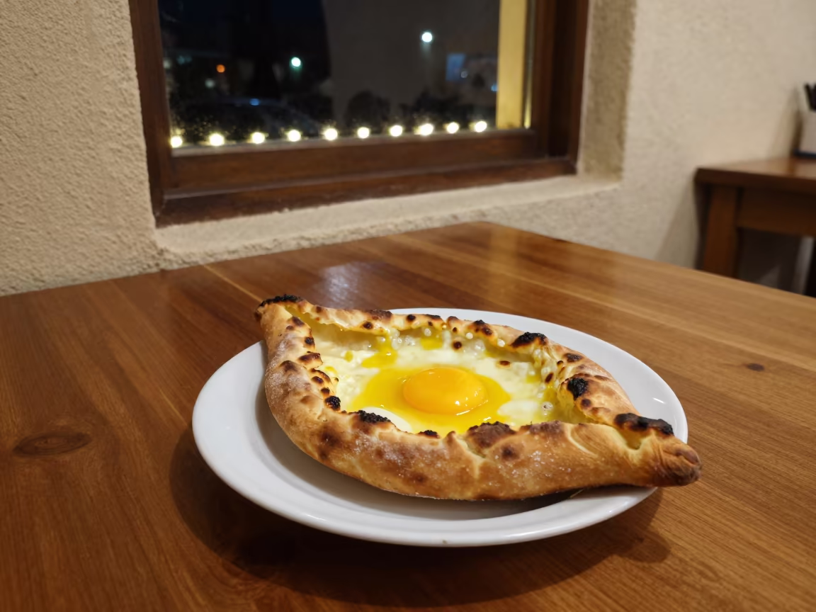 Midnight Khachapuri with Runny Yolk in Ciudad de la Costa in on a cafe table by a window in Ciudad de la Costa