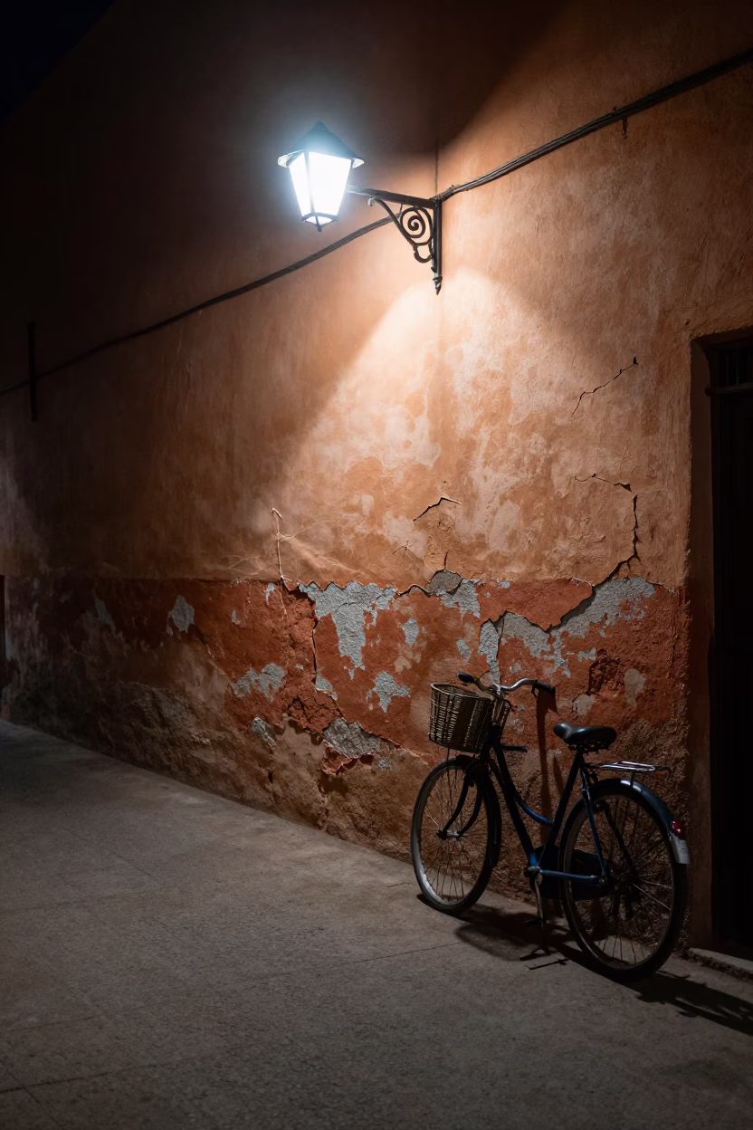 Midnight Marrakech alleyway with cracked stucco and bicycle in in Marrakech, Morocco