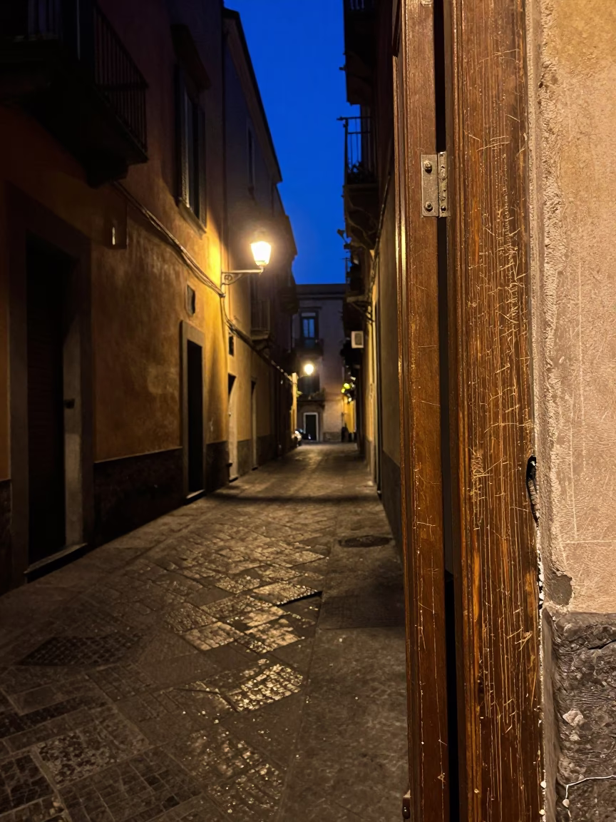 Midnight Naples Street Scene with Scratched Doorframe and Drying Towels in in Naples, Italy
