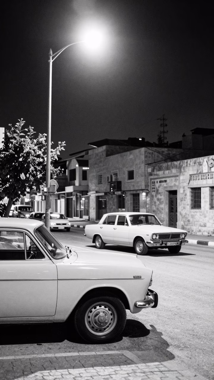 Midnight Street Scene in Amman Jordan with Vintage Cars and Streetlights in in Amman, Jordan