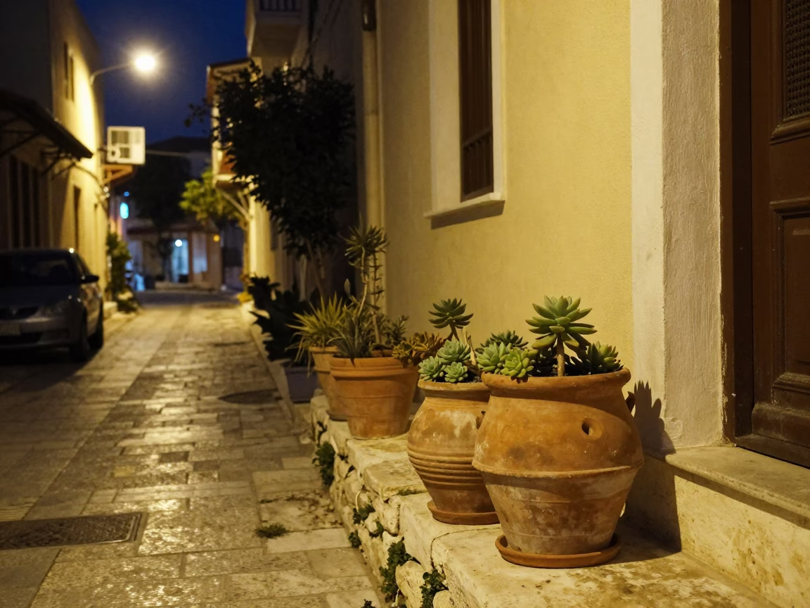Midnight street scene in Athens Greece with terracotta pots and local nightlife in in Athens, Greece