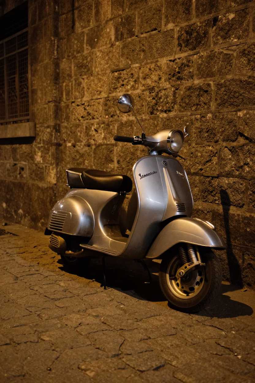 Midnight street scene in Hyderabad India with vintage Vespa on cobblestone lane in in Hyderabad, India