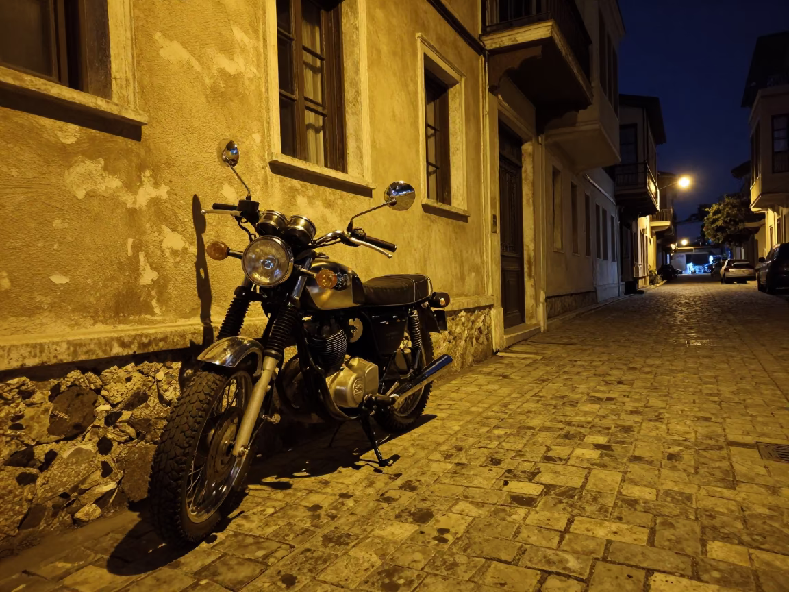 Midnight street scene in Izmir Turkey with vintage motorcycle and dimly lit cafe window in in Izmir, Turkey