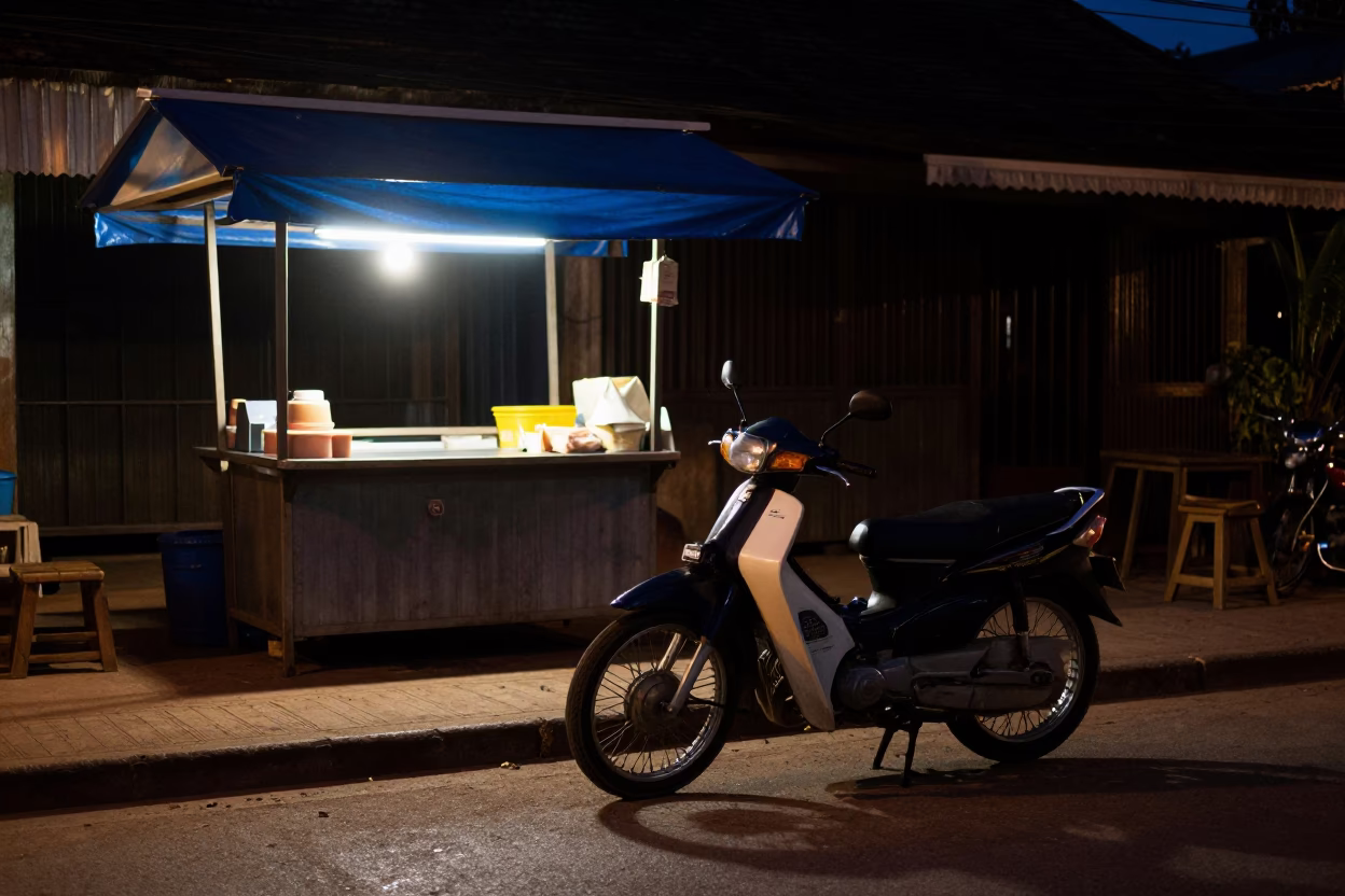 Midnight street scene in Luang Prabang Laos with vintage motorcycle and dim lantern light in in Luang Prabang, Laos