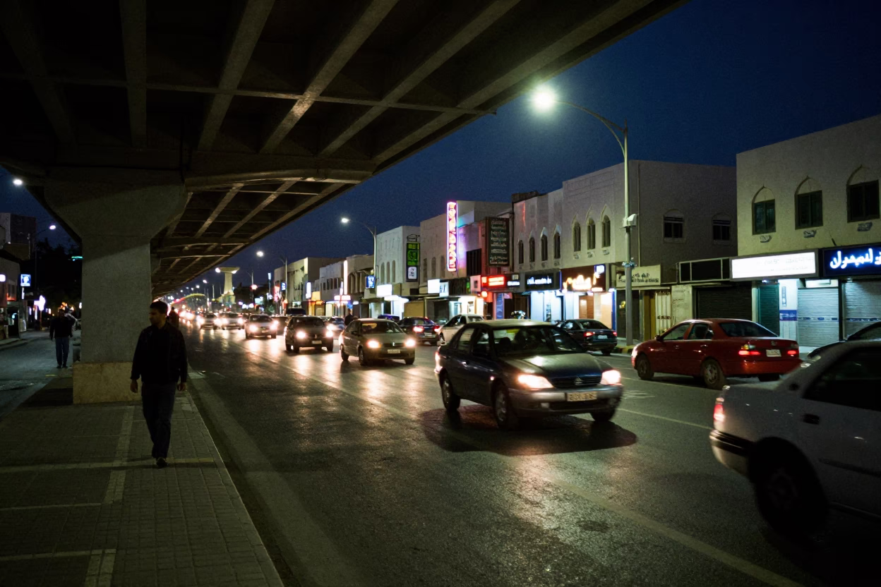 Midnight Street Scene in Muscat Oman with Neon Signs and Traffic Under Flyover in in Muscat, Oman