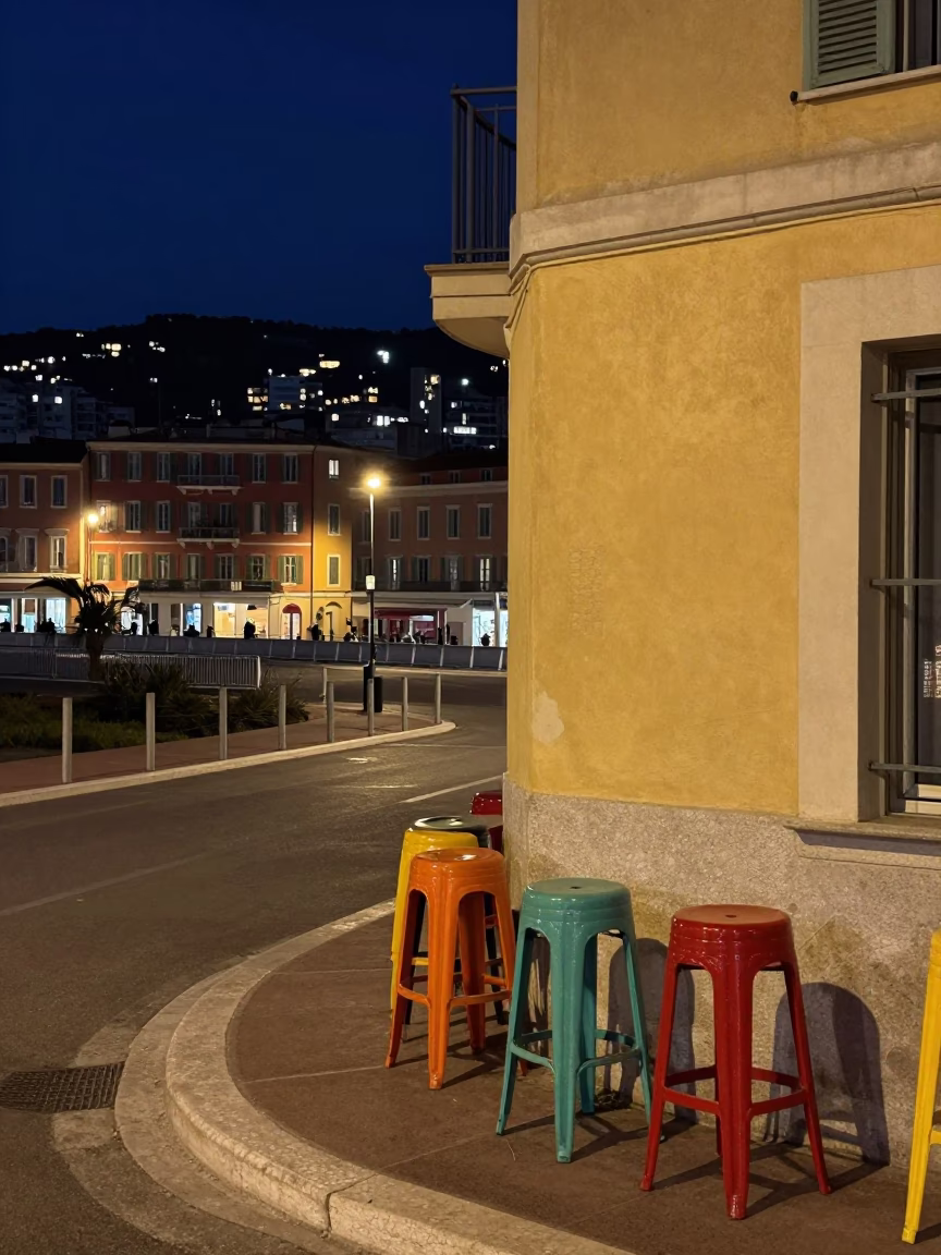 Midnight street scene in Nice France with colorful bar stools and rustic hinge details in in Nice, France