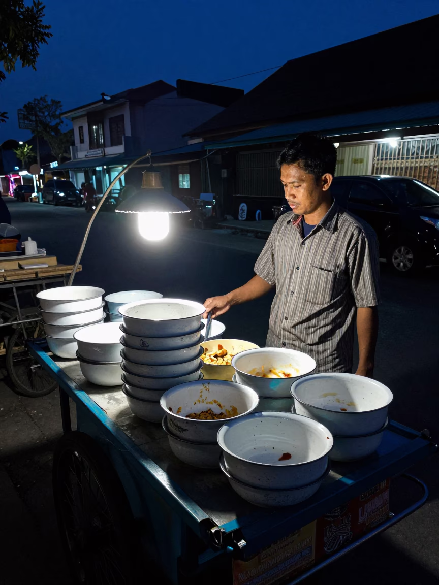Midnight street scene in Yogyakarta Indonesia with enamel bowls and local night activity in in Yogyakarta, Indonesia