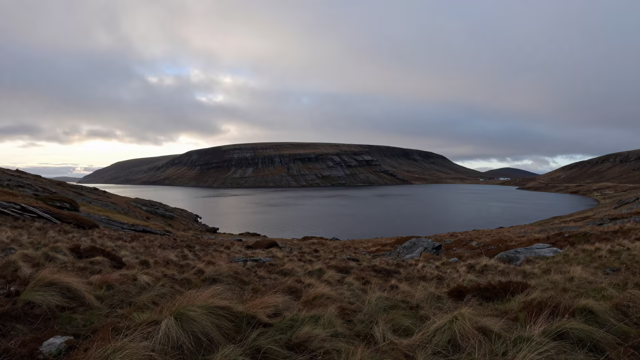 Midnight Sun Over Nordic Lake Ridge in from a ridge above layered foothills in Guinea