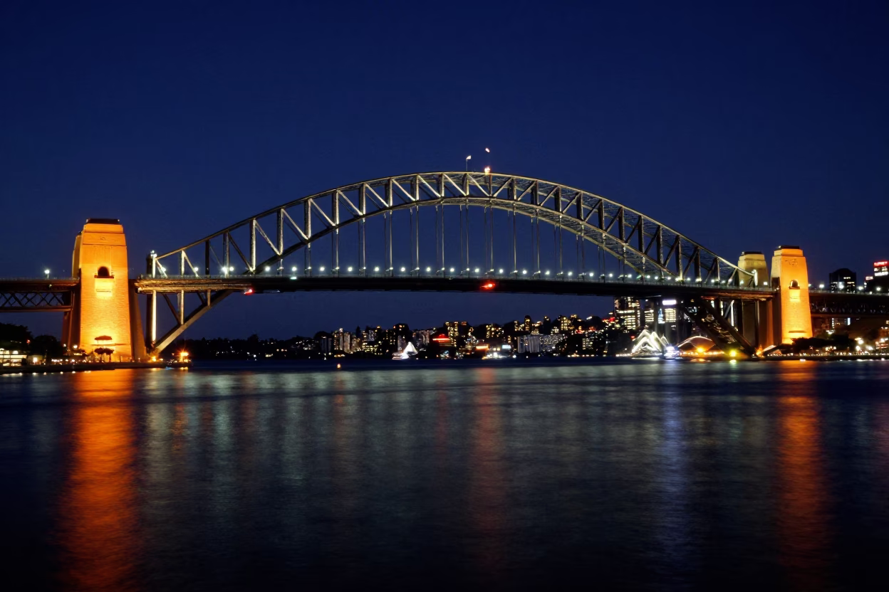Midnight Sydney Harbour Bridge Illumination with Circular Quay Reflections in in Sydney, New South Wales, Australia