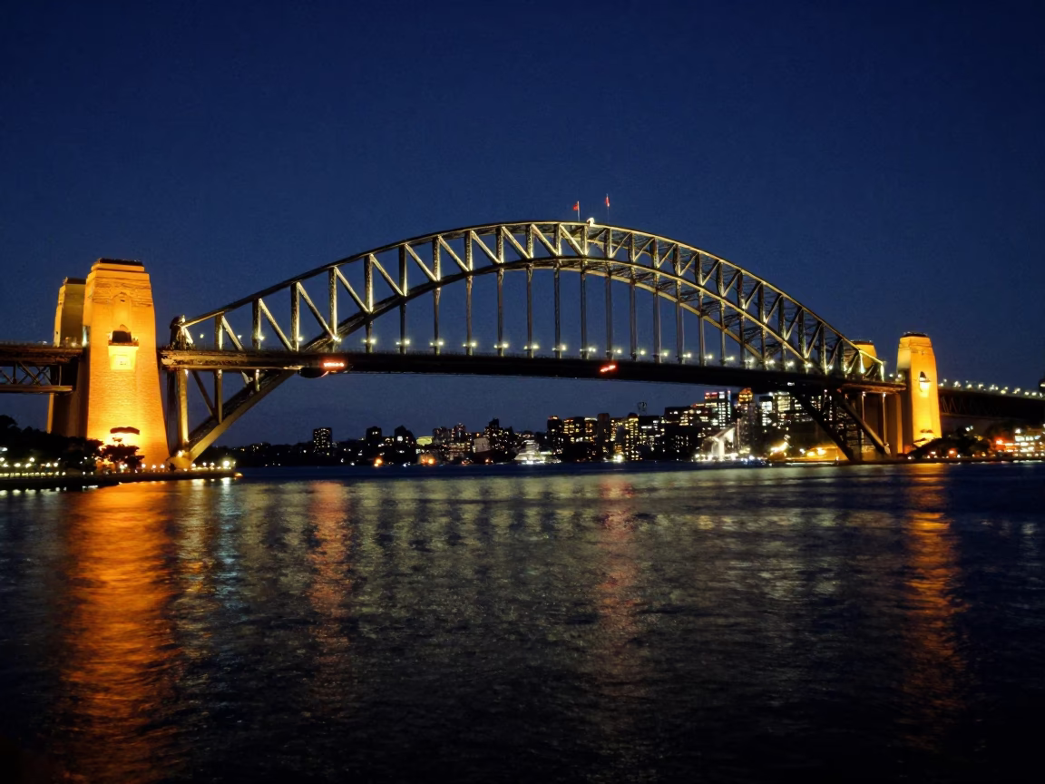 Midnight Sydney Harbour Bridge Illumination with Monorail Reflections in Water in in Sydney, New South Wales, Australia