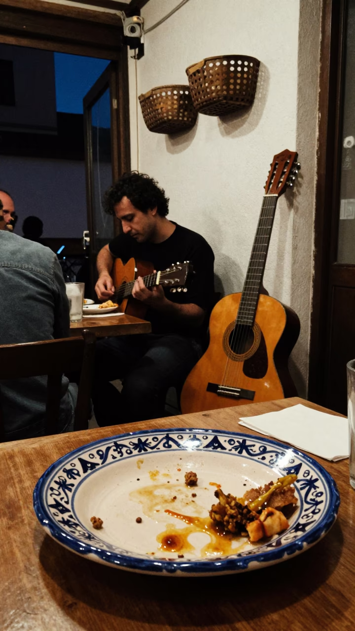 Midnight Tapas Scene in Granada Spain with Guitar and Ceramic Plate in in Granada, Spain