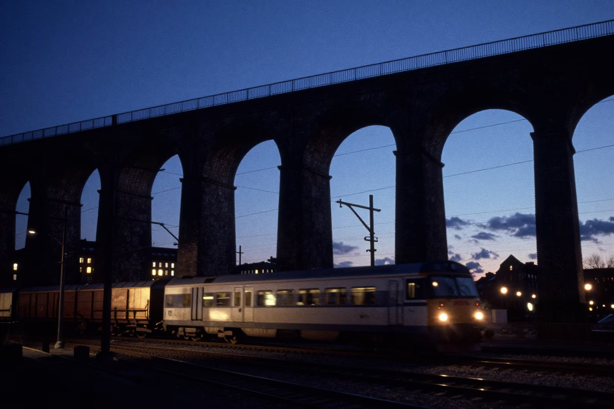 Midnight Urban Landscape of Copenhagen Denmark Railway Viaduct Arches and Passing Freight Train in in Copenhagen, Denmark