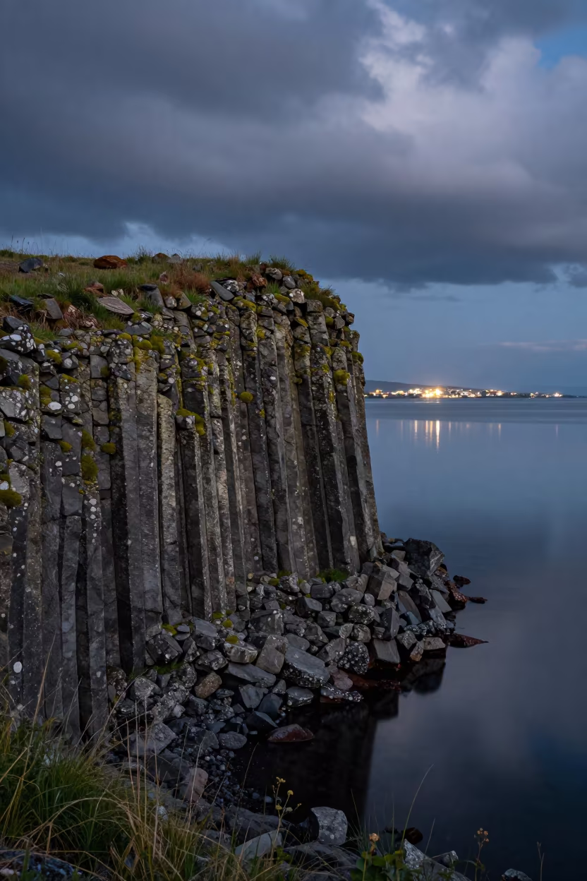 Midsummer Basalt Cliff with Sideways Green Growth in from a ridge above layered foothills near Almaty