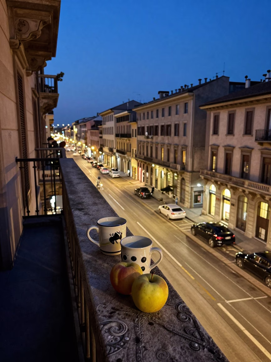 Milan Evening Street Scene with Ceramic Mugs and Apples on Balcony in in Milan, Italy