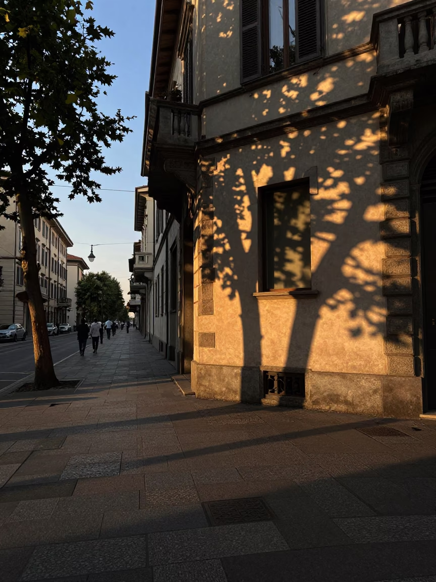 Milan Evening Street Scene with Dappled Shadows and Local Cafe Details in in Milan, Italy