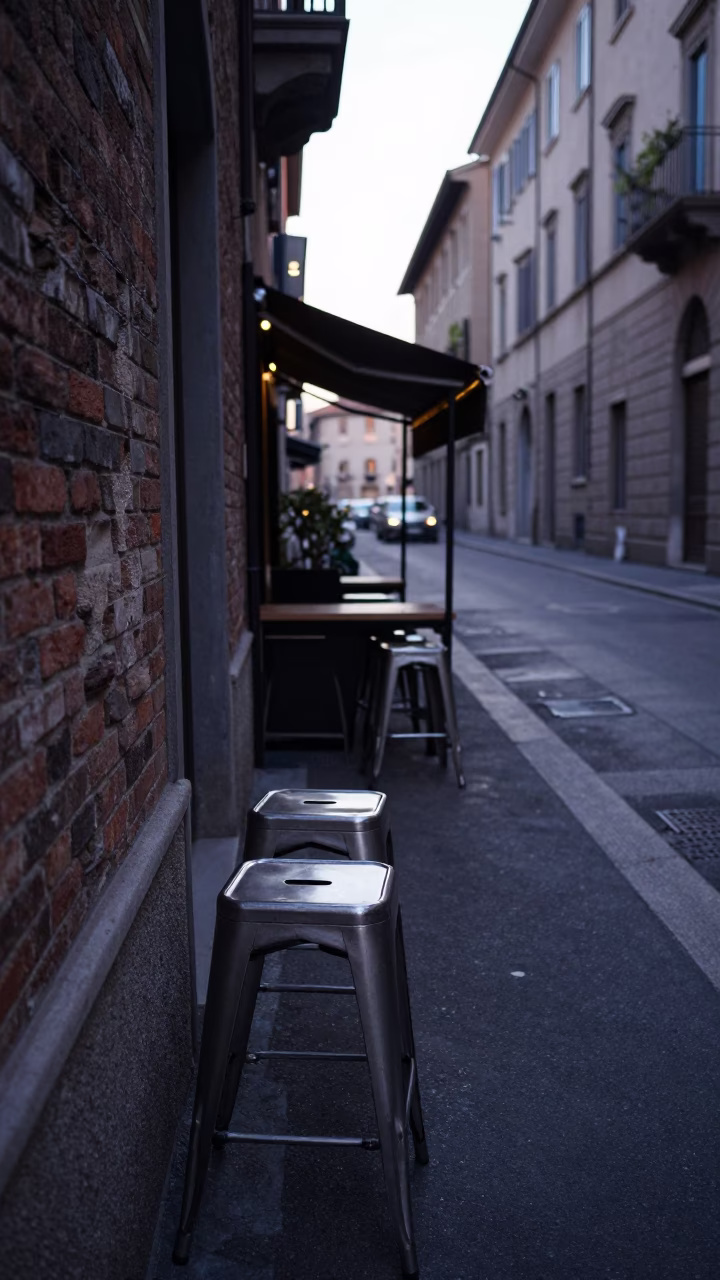 Milan Italy Pre-Dawn Street Scene with Brushed Steel Stool and Cardigans in in Milan, Italy