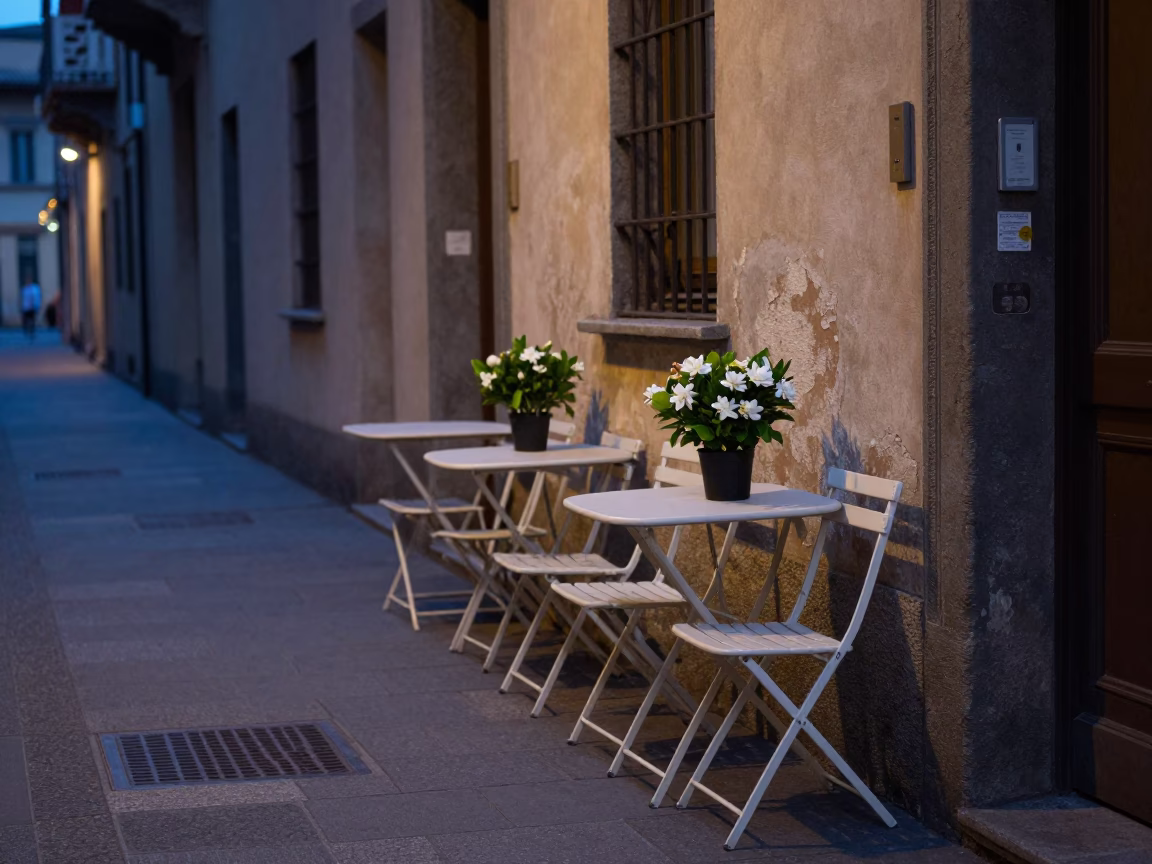 Milan Italy pre-dawn street scene with folding tables and gardenia bush in in Milan, Italy