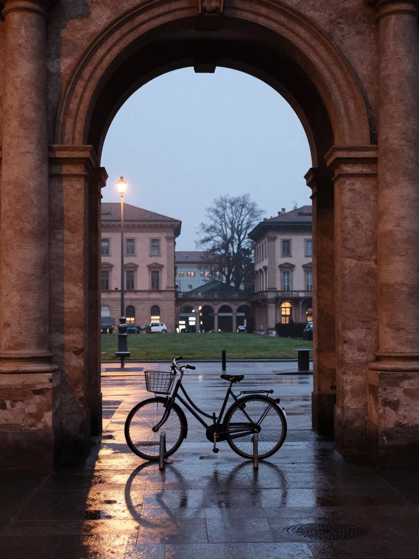 Milan Italy pre-dawn university archway framing wet bicycle rack and stone details in in Milan, Italy