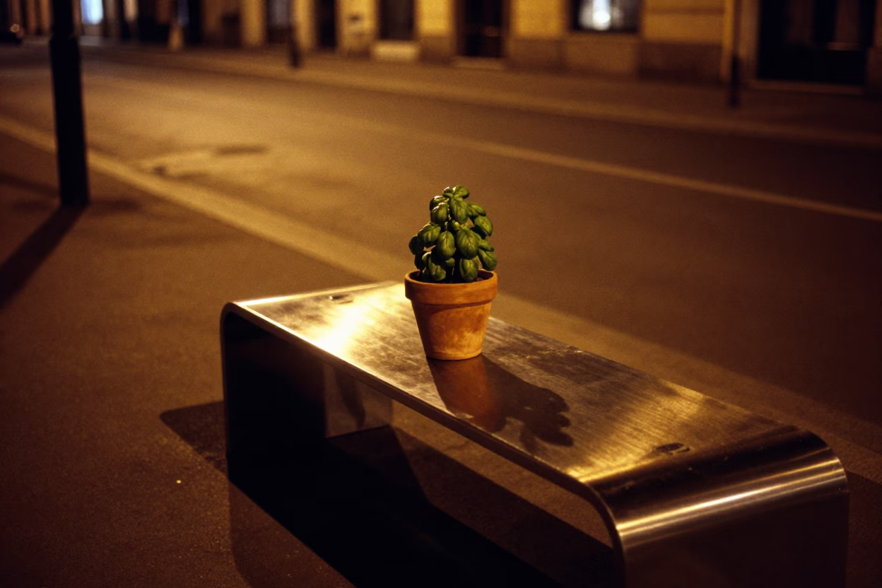 Milan Night Street Scene with Brushed Steel Bench and Basil Pot in 1990s Italy in in Milan, Italy