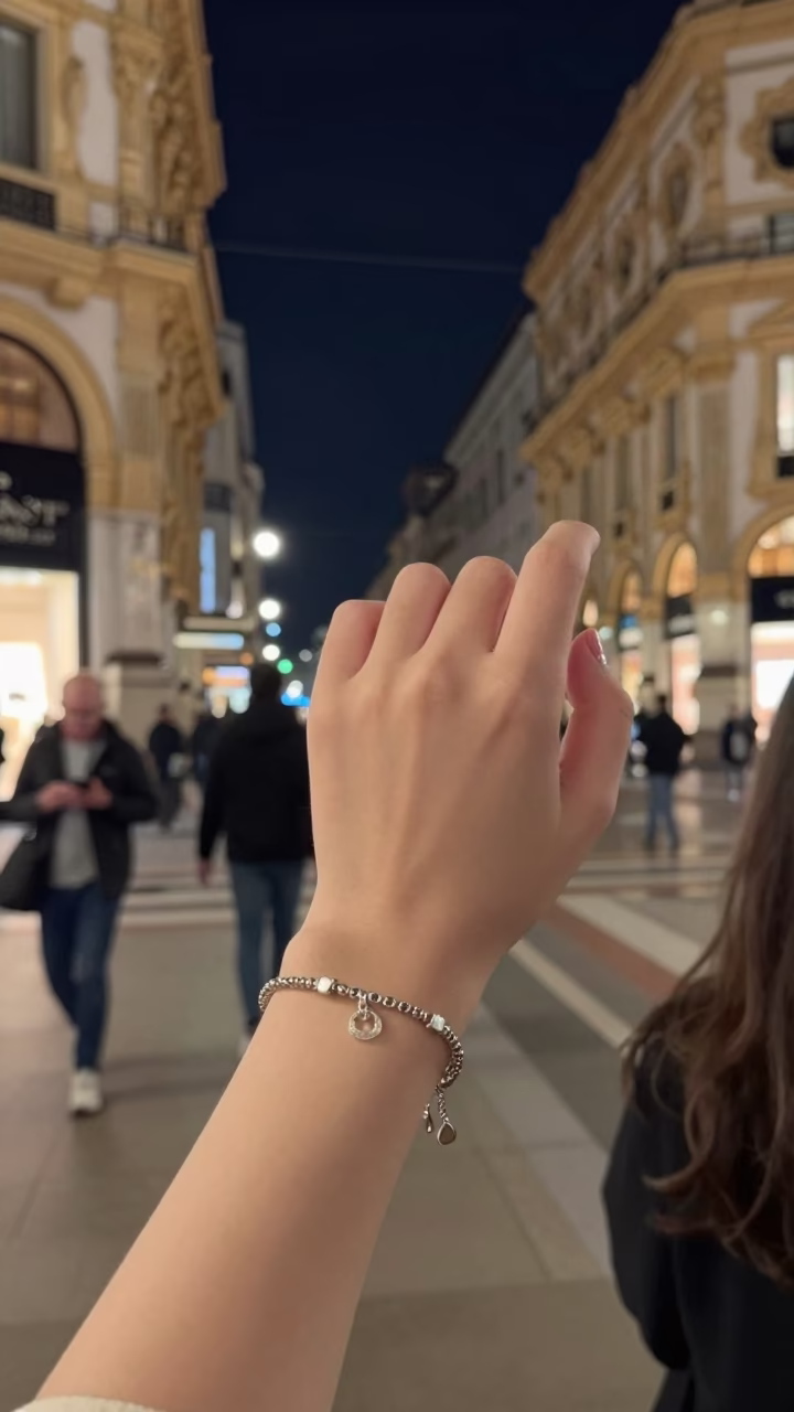 Milan Night Street Scene with Charm Bracelet and Finger Smudges on Glass in in Milan, Italy