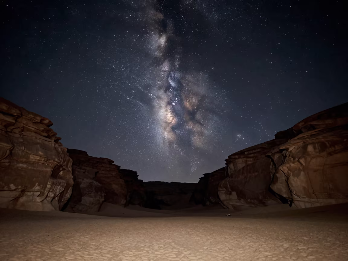 Milky Way Core Over Egyptian Desert Canyon Night in beneath thin cloud gaps and stars in Egypt